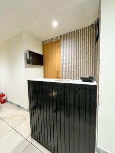 a kitchen with a black bar in a room at Atithi in Hisār