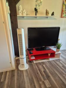 a flat screen tv sitting on a entertainment center at Ferienwohnung Studio 5 in Siegsdorf