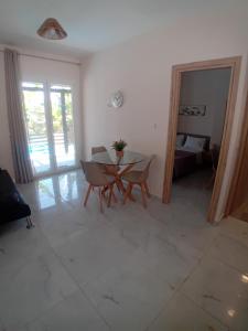 a living room with a table and chairs and a bedroom at Elysian Suites in Ratzaklíon
