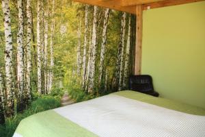 a bedroom with a bed with a mural of aspen trees at Retiro Da Arminda in Canedo