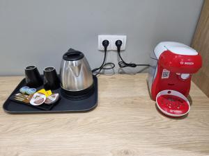 a coffee maker sitting on a counter next to a blender at Xanthi Studio Apartments in Katerini