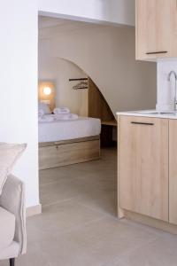 a bedroom with a bed and a stairway at Artemaris by Seaward Suites in Villajoyosa