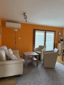 a living room with a couch and a table at Ferienhäuser Holenberg in Holenberg +27 photos