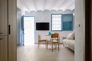 a living room with a table and a couch at Artemaris by Seaward Suites in Villajoyosa