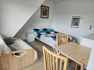 a bedroom with a bed and a table and a couch at Zakątek przy Wydmie in Dziwnów