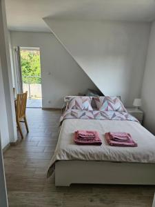 a bedroom with a bed with two towels on it at Zakątek przy Wydmie in Dziwnów