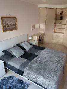a bedroom with two beds and a desk in it at Apartament orhideja 11 in Riga