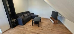 a living room with a couch and a television at Ellenberg Appartements - Ferien- und Monteurs-Wohnung in Geislingen