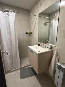a bathroom with a shower and a sink and a shower at Amalfi Apart in Villa María +18 photos