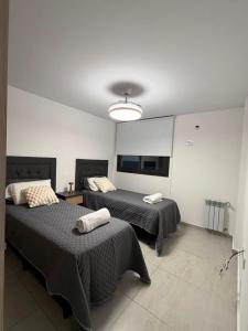 a bedroom with two beds and a ceiling at Amalfi Apart in Villa María