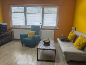 a living room with a couch and two chairs and a table at Schwarzer Kater in Hochstetten-Dhaun