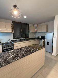 a kitchen with a granite counter top in a kitchen at Amalfi Apart in Villa María