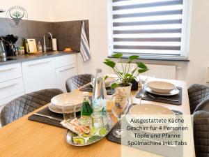a dining room table with plates and dishes on it at Stierpartment am Pfälzer Wald nähe Outlet Center Zweibrücken in Pirmasens