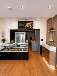 a bakery with a display case filled with donuts at Hotel Albergo in Brussels