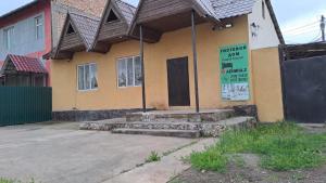 a building with a sign on the side of it at Apartmenthouse in Naryn