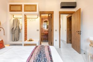 a bedroom with a bed and a closet at Casa Tortuga - Exclusive Villa Corfu in Acharavi