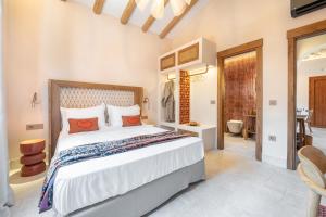a bedroom with a large bed and a bathroom at Casa Tortuga - Exclusive Villa Corfu in Acharavi