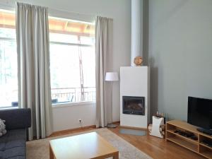 a living room with a couch and a fireplace at Saimaan Rantavilla Zebra in Imatra