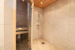 a bathroom with a shower and a walk in shower at Ailakka, huoneisto A in Kilpisjärvi +11 photos