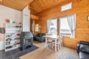 a living room with a stove and a table at Ailakka, huoneisto A in Kilpisjärvi