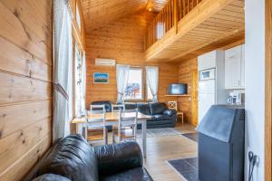 a living room with a table and a couch at Ailakka, huoneisto A in Kilpisjärvi
