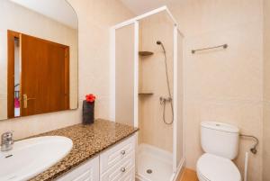 a bathroom with a toilet and a sink and a shower at Villa Estrella in Cala en Blanes +10 photos
