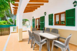 a dining room with a table and chairs at Villa Estrella in Cala en Blanes