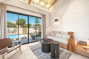 a living room with a couch and a large window at Casa Tortuga - Exclusive Villa Corfu in Acharavi