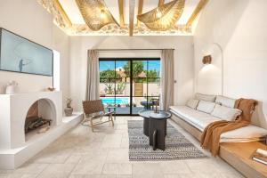 a living room with a couch and a fireplace at Casa Tortuga - Exclusive Villa Corfu in Acharavi