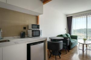 a kitchen and living room with a couch and a microwave at La Vita Bao in Phuket +22 photos