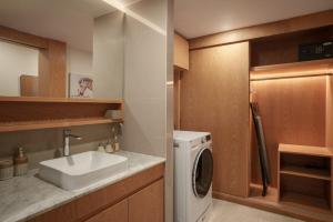 a kitchen with a sink and a washing machine at La Vita Bao in Phuket