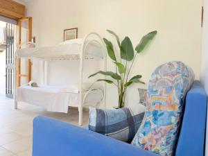 a living room with a bunk bed and a couch at Villetta Chiara in Baia Verde