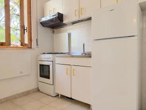 a kitchen with white appliances and a white refrigerator at Villetta Chiara in Baia Verde