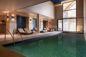 a swimming pool with lounge chairs and a swimming pool at Renaissance Aix-en-Provence Hotel in Aix-en-Provence