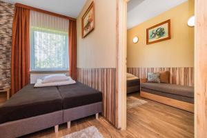 a bedroom with two beds and a window at Baron in Sztutowo +55 photos