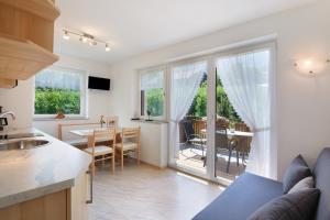 a kitchen and living room with a table and a dining room at Reiterhof Siglgut in Laces +75 photos