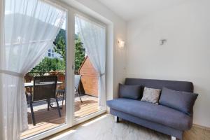 a living room with a couch and a large window at Reiterhof Siglgut in Laces