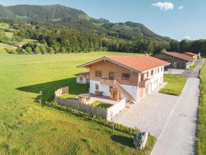 a small house in a field with a fence at Alpen Lodge Samerberg in Samerberg