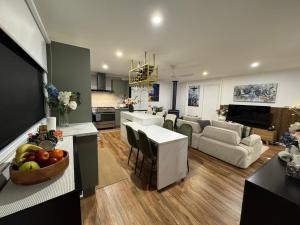 a large living room with a kitchen and a living room at Brigidas Guest House in Bairnsdale