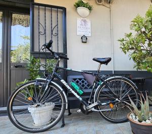 a bike parked next to a bench in front of a door at Casa Vacanze VENER - Venosa in Venosa