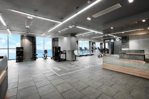 a large room with a gym with exercise equipment at Nha Trang Oceanview Suites in Nha Trang