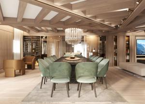 a dining room with a table and green chairs at Campiglio PLAZA in Madonna di Campiglio