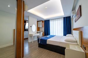 a hotel room with a bed and a bathroom at Hey Lara Hotel in Antalya