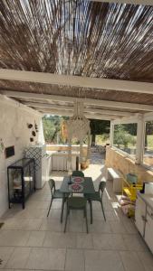 a patio with a table and chairs and a ceiling at La Mia Lamia in Cisternino