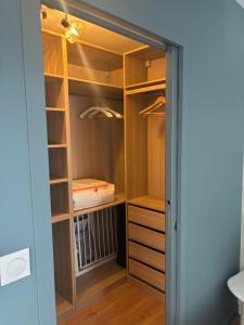 a walk in closet with a door open at Résidence les 3 volcans 4 étoiles in Clermont-Ferrand +33 photos