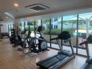 a gym with a row of treadmills and elliptical machines at La Vita Bao in Phuket