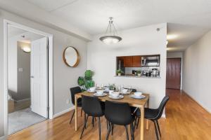a dining room with a wooden table and black chairs at Relaxing Arlington Apt - Pool - near Pentagon City in Arlington
