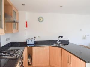 a kitchen with a sink and a stove top oven at Sea Drift in West Bay