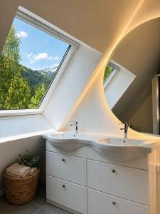 a bathroom with two sinks and a large window at Residence L'Horizon in Murat-le-Quaire +28 photos