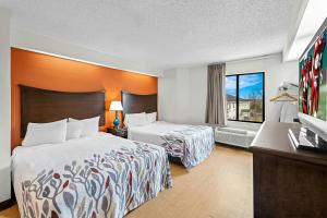 a hotel room with two beds and a television at Red Roof Inn Branson in Branson +31 photos
